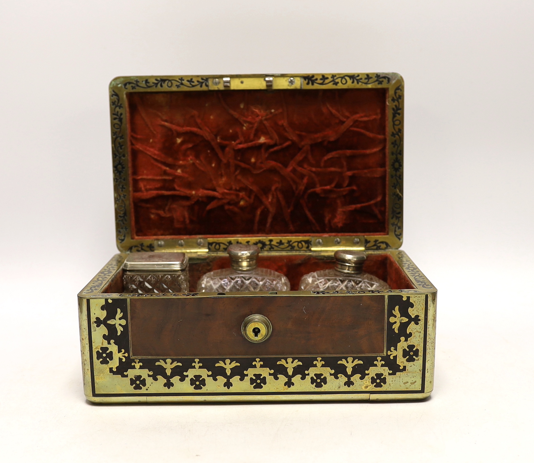 A William IV Cut brass, mahogany and ebony travelling vanity box, with silver-capped bottles, 24.5cm wide